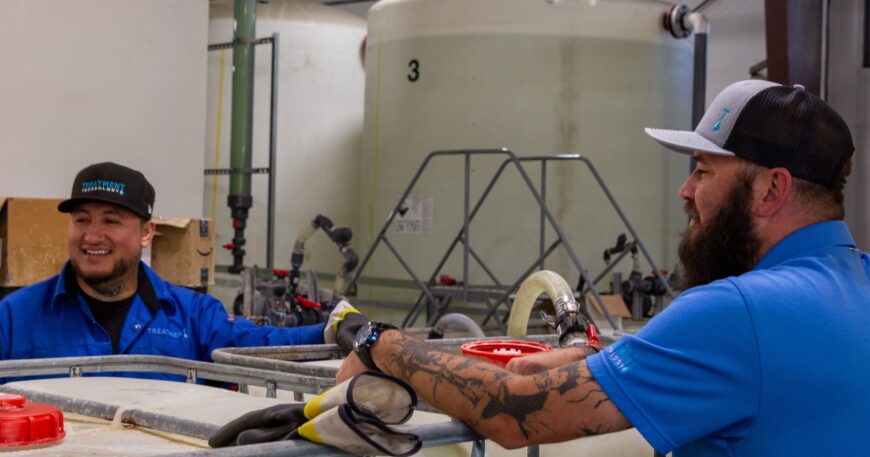Treatment Tech employees preparing a chemical mixture for delivery